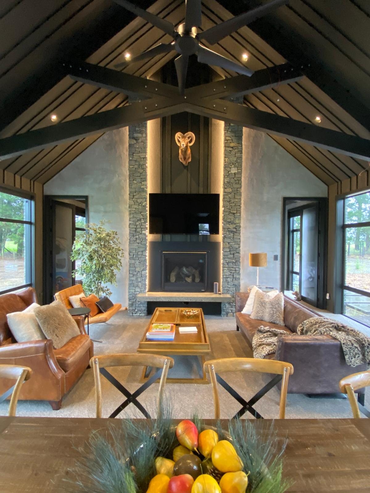 130 Kereru Road — vaulted living room with schist fireplace